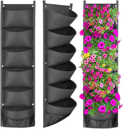 Vertical wall garden with black fabric pots holding flowers
